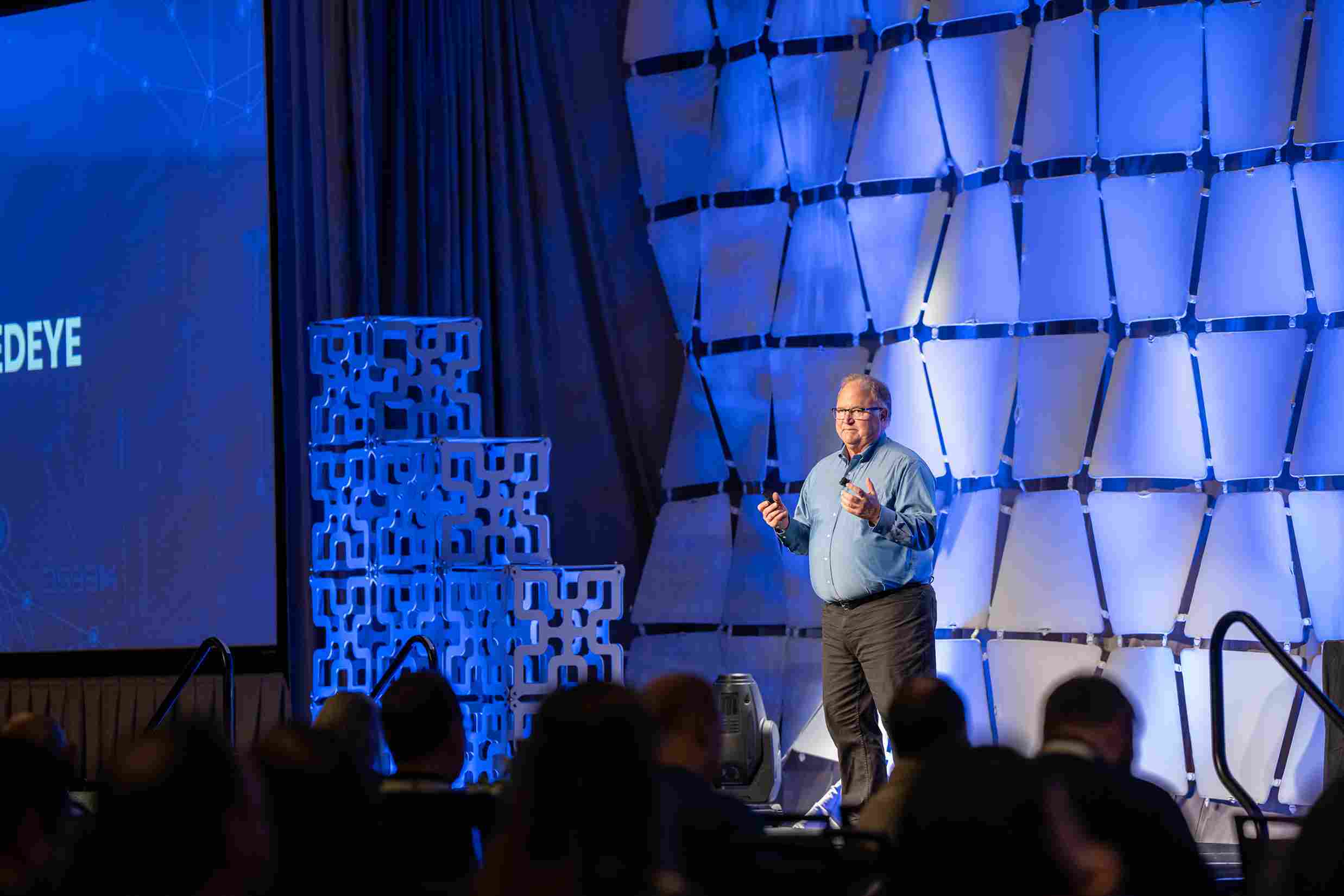 Accruent President Richard Leurig presenting on stage at a professional conference.