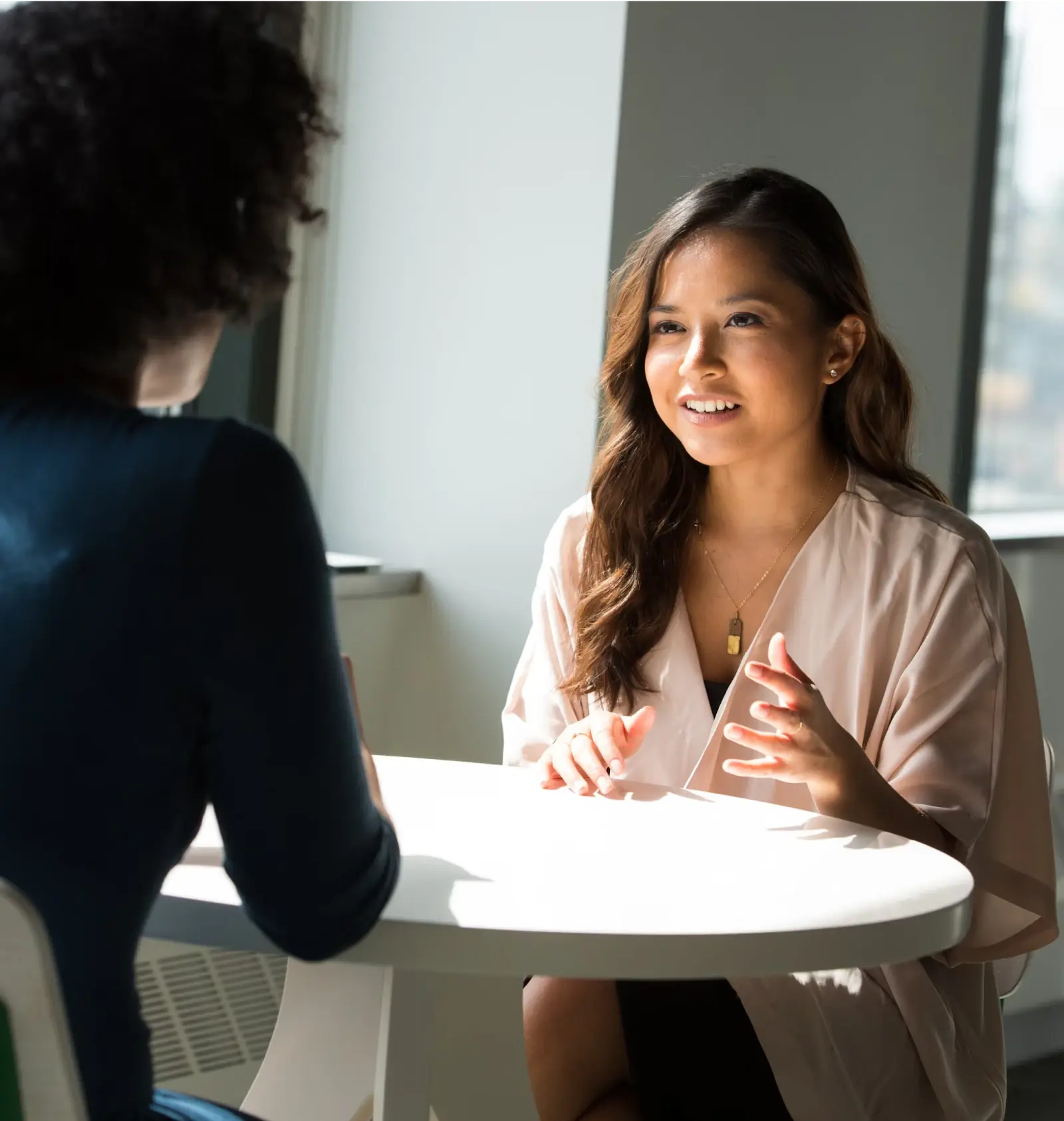 Two professionals in a modern office discussing business, representing trust by 5000+ customers globally.