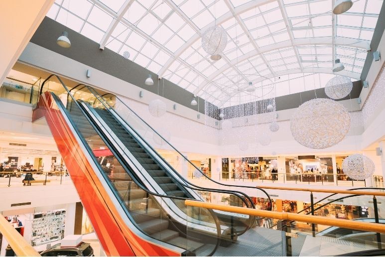 Interior of a multi-level retail shopping center with escalators and common areas