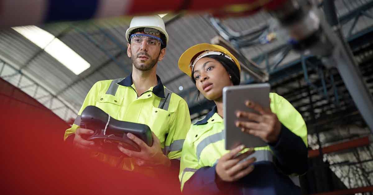 Two engineers working in safety gear
