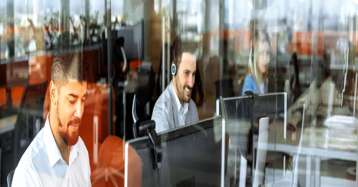 Call center employees working at their desks in an office